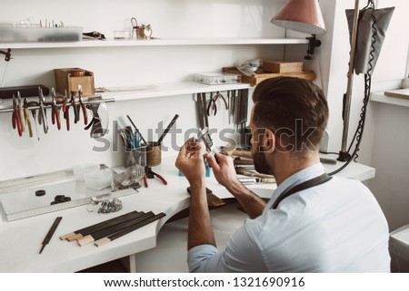 Similar – Image, Stock Photo Mature jeweler creating gold item using a pencil in workshop