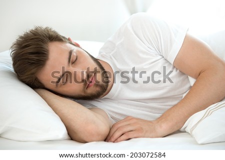 Man sleeping on white bad