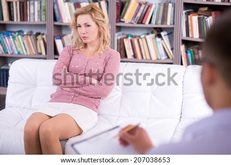 Woman talking to her psychologist and sitting on the couch