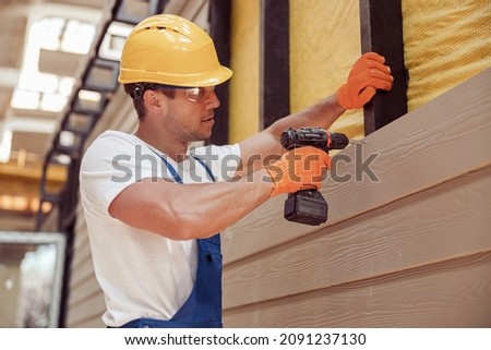 Image, Stock Photo Male worker using electric grinder in workshop