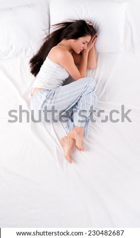 Woman sleeping in fetal position