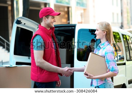First class delivery service. Courier Delivering Package By Van.