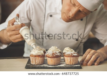 Similar – Foto Bild Männlicher Bäcker schiebt Kuchen in den Ofen