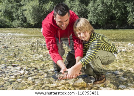 Happy father and son with caught fish