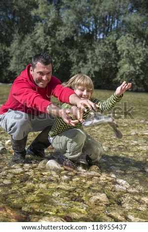 Father and son release a fish