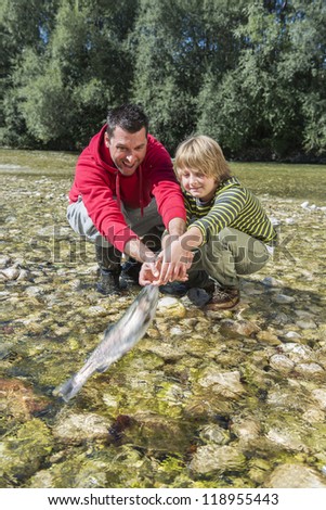 Father and son release a fish