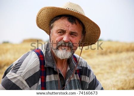 Portrait of senior farmer on his wheat field