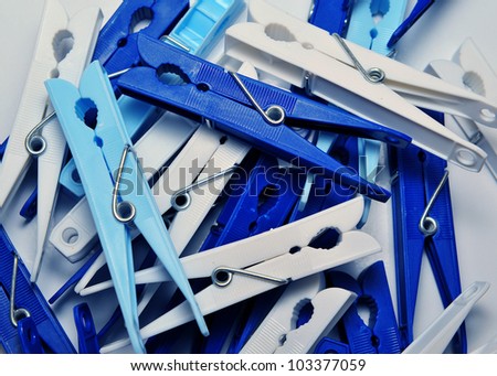 Many blue and white plastic clothes pins