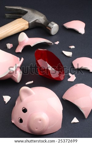 Broken piggy bank revealing a ruby gemstone conveying a sense of wealth and luck. Business & finance concepts.