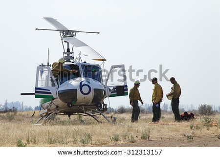 Omak, WA, USA August 21, 2015: Fire fighters on the helicopter crew at the Omak Airport prepare to fight the Okanogan Complex Wild Fire, the largest, most destructive fire in Washington State history