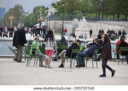 PARIS - APRIL 24: People in the famous Tuileries garden on 2013 in Paris. Tuileries Garden is a public garden located between the Louvre Museum and the Place de la Concorde and very popular sitte