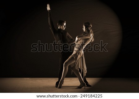 The Latino dancers in ballroom isolated on black background