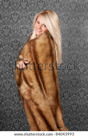 Elegant young lady in a fur coat