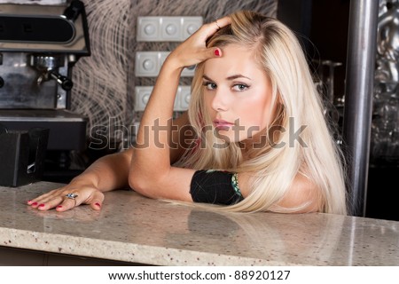 Attractive young blond woman at bar table