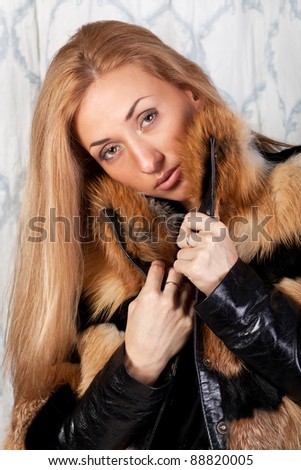 Beautiful brunette model in elegant fur coat