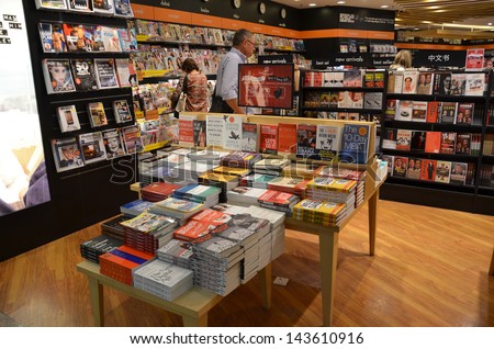 SINGAPORE-JUNE 14: Customers shop for books in Changi Airport, Singapore on June 14, 2013. Singapore airport provides the best shopping experience to the passengers.