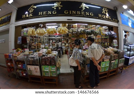 SINGAPORE-JULY 06: Customers shop for Chinese herb in traditional chinese medicine shop on July 06, 2013 in Singapore. Singapore\'s appetite for traditional Chinese medicine leapt over the years.