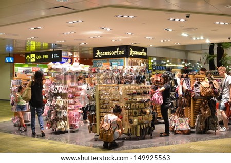 SINGAPORE-JULY 31: Passengers do some shopping before take off on July 31, 2013 in Changi Airport, Singapore. Singapore airport provides the best shopping experience to the passengers.
