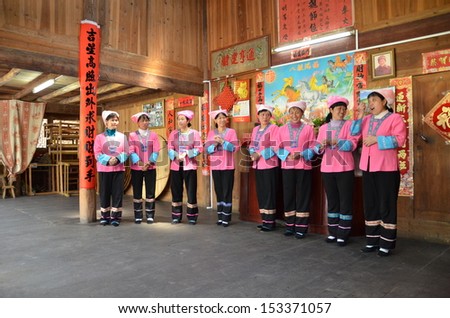 GUILIN, CHINA - MARCH 24: Women from China minority group perform their traditional dance on March 24, 2012 in Guilin, China. Tourists are usually welcome with ethnic minority dance performance.