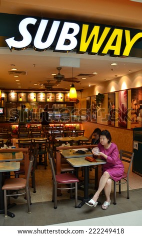SINGAPORE - 05 OCT, 2014: Customer is having her lunch in Subway restaurant in Singapore. As now, there are over 70 Subway outlets in Singapore.