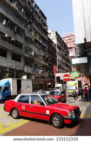 HONG KONG - MARCH 19: Taxi and unidentified people near Mong Kok metro station on March, 19, 2013. Over 90% daily travelers use public transport. Its the highest rank in the world.