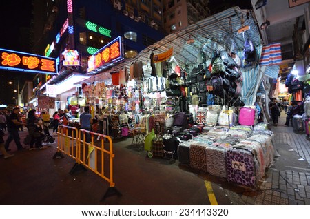 HONG KONG - NOVEMBER 22 :Tourist shops for bargain priced fashion and casual wear in Mong Kong market on 22 November 2014. The market is famous with many booths selling local products.