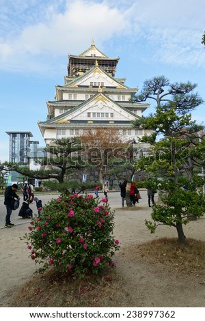 OSAKA, JAPAN - DECEMBER 04 2014: Tourists visit Osaka Castle in Japan on December 04, 2014. Osaka Castle was first built in 1583 on the former site of the Ishiyama Honganji Temple.
