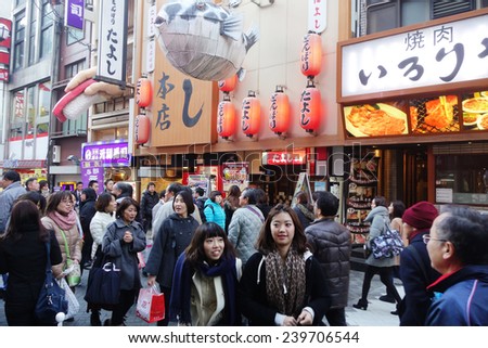 OSAKA, JAPAN - DECEMBER 13: Unidentified customers queue to buy takoyaki in Osaka on December13, 2014. Takoyaki is one of the most famous food in Osaka, Japan