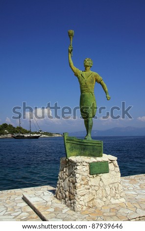 Greece Greek Isles Paxos Statue of a young at the old harbor entrance - Paxos landmark