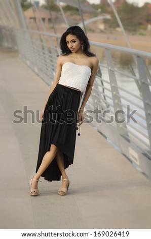 Full length photo of beautiful exotic elegantly dressed young woman