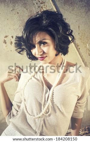 Beautiful exotic young woman with cool funky short black hair and sweet elegant fashion style