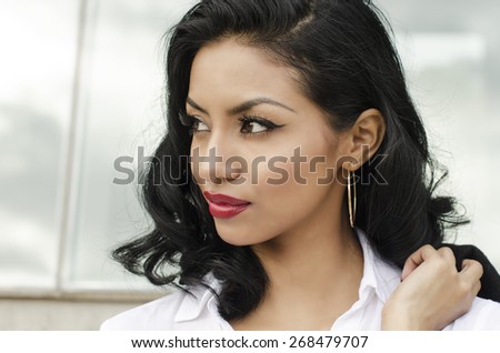 Attractive woman - well dressed - looking to side