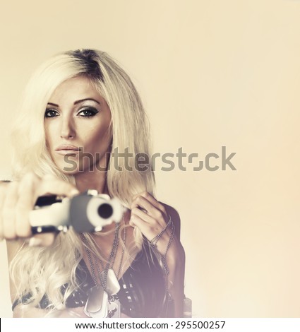 Beautiful blonde woman  shooting gun