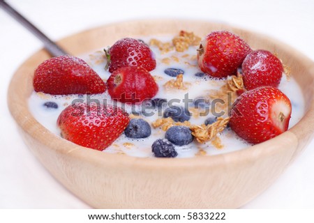 Healthy cereal breakfast, oats, blueberries and strawberry\'s with low fat skimmed milk.