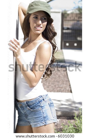Beautiful young woman in shorts wearing cap