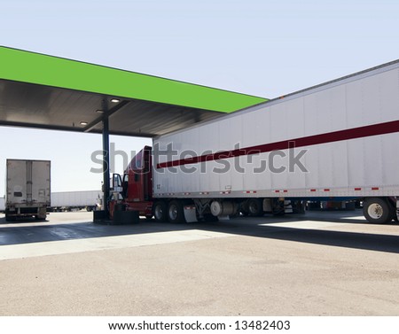 Truck at fuel stop off highway.