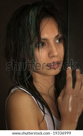 Beautiful young woman wet with wild look in her eye looking away from camera