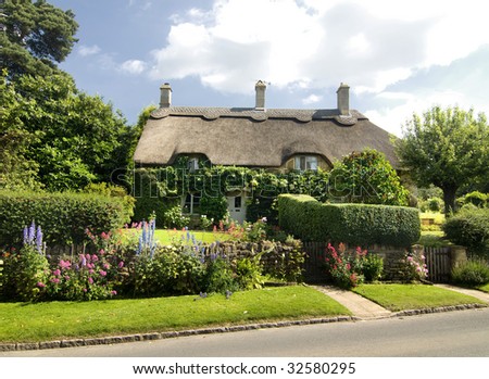 Beautiful rural cottage with thatched roof in the Cotsworld countryside of England