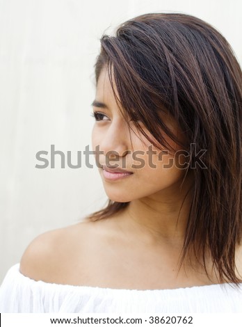 A side profile portrait of a cute young Asian woman
