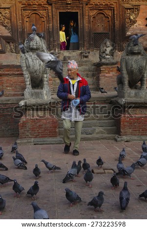PATAN DURBAR SQUARE, NEPAL-MAR 23 : A man walking out from one of temple in Durbrar Square, on March 23, 2013. Patan Durbar Square It is one of three Durbar Squares in the Kathmandu Valley in Nepal.