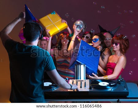 girls receiving presents and playing with them, at a party, with dj mixing music