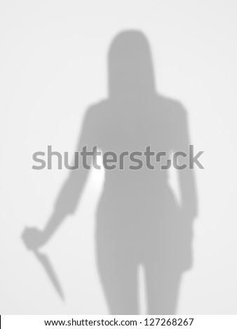 female silhouette holding a knife in her hand behind a diffuse surface