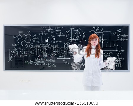 general-view of a pretty girl student in a chemistry lab looking amazed into the camera and conducting a magical gas experiment  with a blackboard on the background