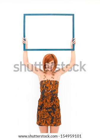 young caucasian woman holding an empty frame on top of her head, on white background