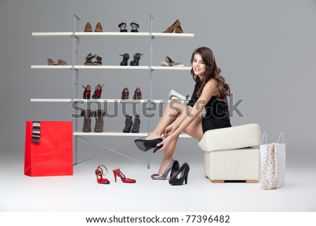 young woman trying on black high heels