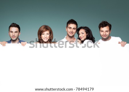 group of funny friends holding a blank banner