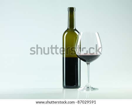 bottle of wine and glass with red wine, copy space