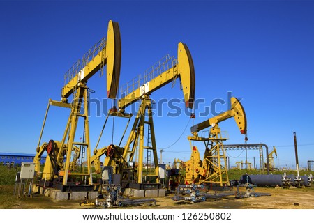 Oil and gas industry. Work of oil pump jack on a field.