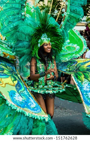 LONDON, ENGLAND - AUGUST 26: A street dancer wearing a feathered headdress and costume at Notting Hill Carnival on August 26, 2013 in London