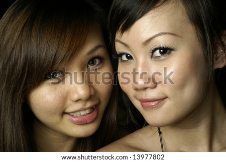 Two happy asian lady friends